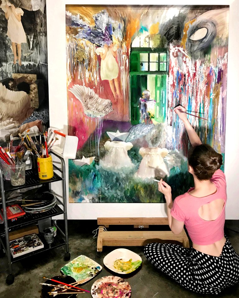 Maxine Syjuco painting in the artist studio