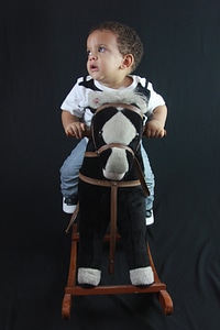 Son happy toy horse photo