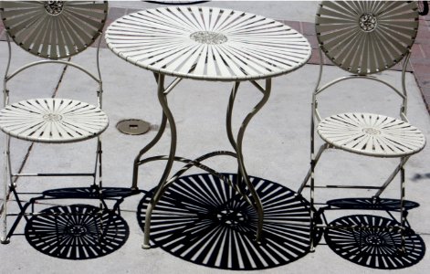 shadows of metal table and chairs photo