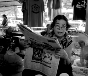 Reading woman, Mae Phim market. Thailand photo
