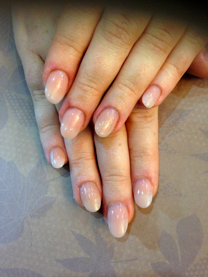 Almond shape nails with peach blush acrylic and bronzed glitter gel on ring fingers.