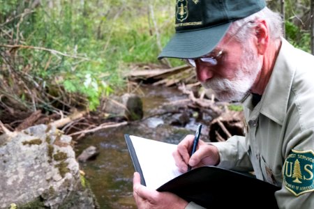 Forest Service Ranger Writing in Logbook-Fremont Winema photo