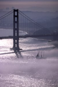 Golden Gate Bridge in fog 2 (with sailboat) photo