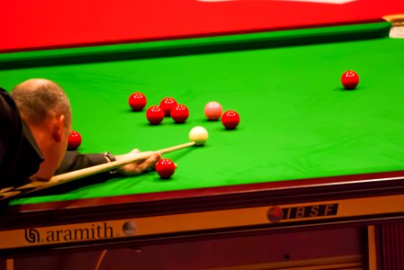 Snooker Player Aiming for a Red Ball