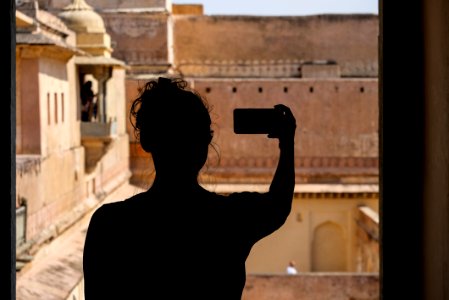 Silhouette of a Tourist Girl Taking a Selfie photo