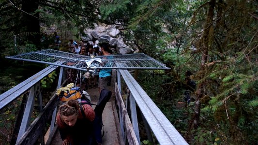 Hiker crawling under gate on a bridge Sept. 2. Photo by Noah Brown