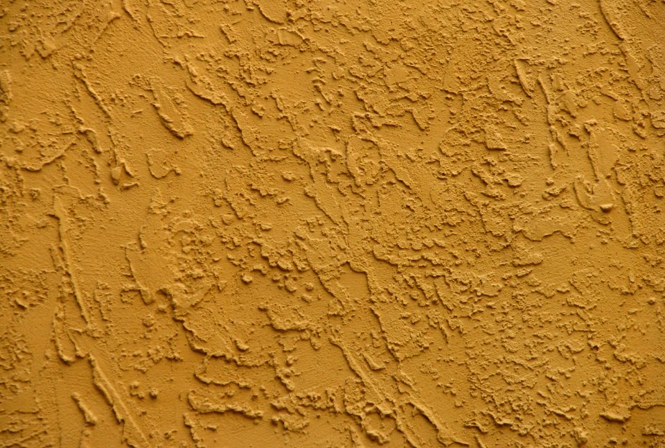 mustard-colored stucco wall