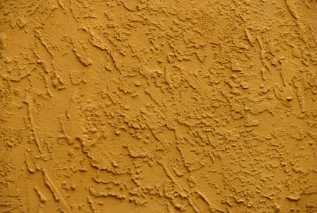mustard-colored stucco wall