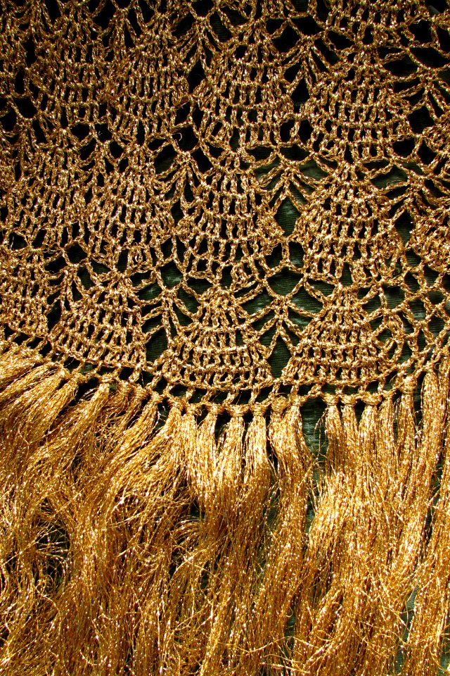 gold woven fabric with fringe