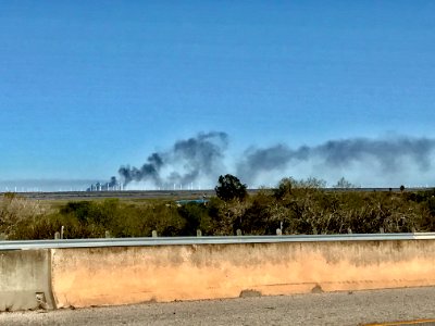 Oil & gas factory explosion to black huge smoking in farm distance about 10 miles from us. South Texas Coastal.