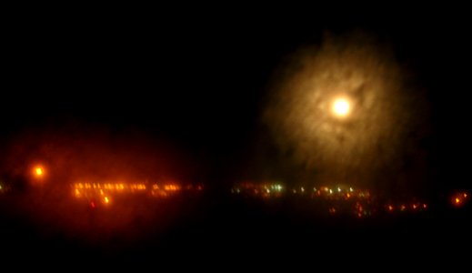 haloed moon with city lights photo