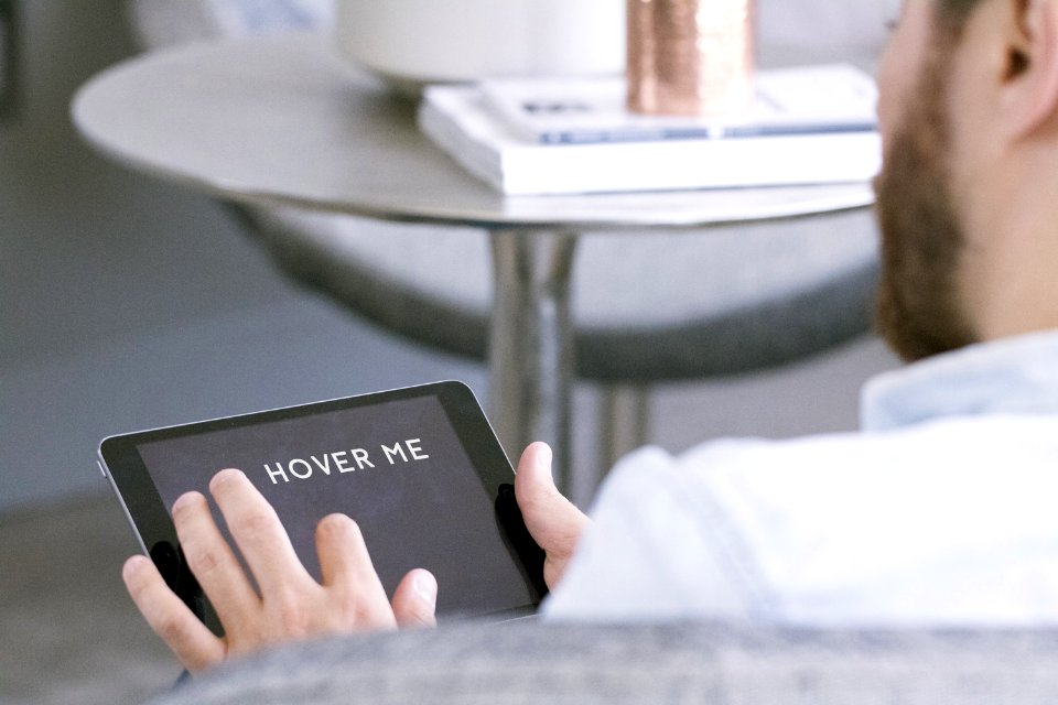 CodiePie Man Sitting On Arm Chair Using Tablet
