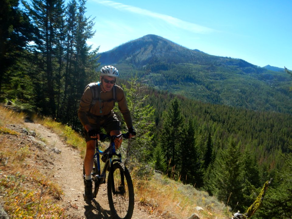 Mountain biker on the Pacific Northwest Trail above Sherman Pass, Colville National Forest