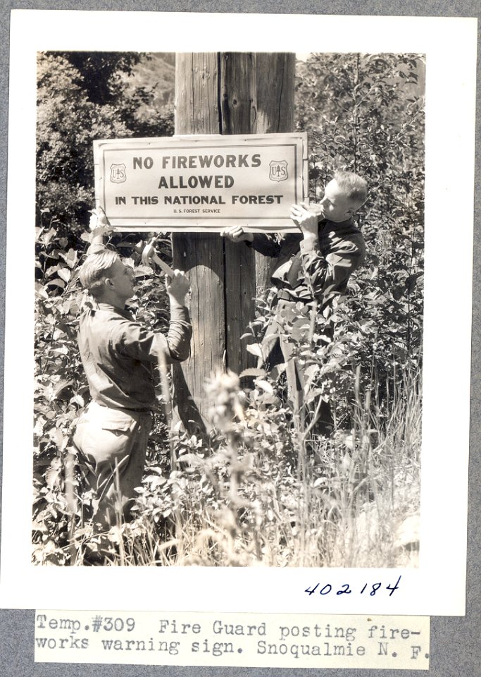 Fire guard posting fireworks sign, Snoqualmie N.F