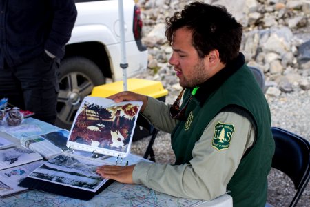 Forest Ranger showing Historical Photo at Artist's Ridge, Mt Baker Snoqualmie National Forest