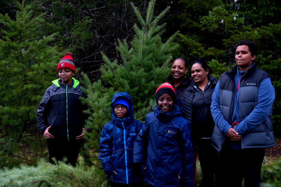 A family poses with their tree at a holiday tree outing at Gifford Pinchot National Forest, November 2018.  Photo by Sandy Burks.