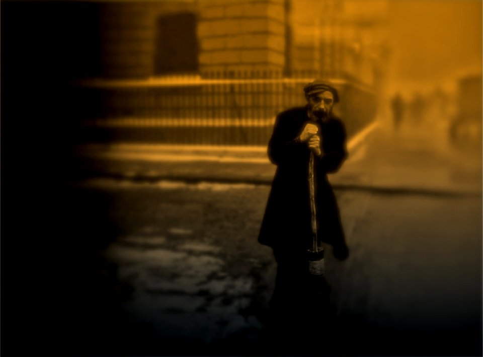 MAN SWEEPING STREET LIGHT