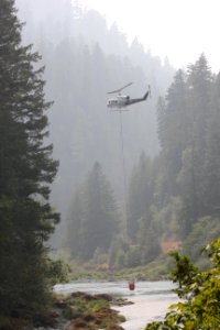 A helicopter dips a bucket of water out of the North Umpqua River on Wednesday, Aug. 23, 2017, Umpqua North Complex. Tim Mowry, Alaska Interagency Incident Management Team