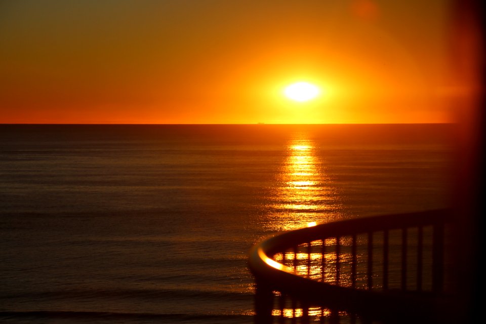 Sunrise, Day meeting Night on beach photo