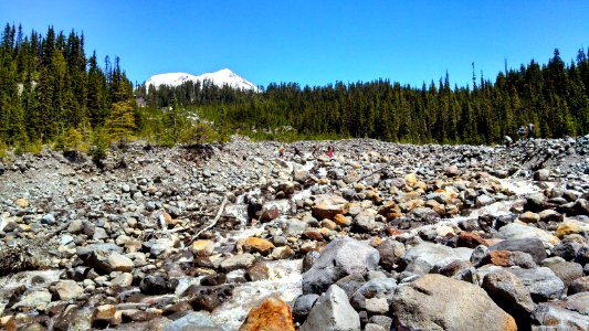 Hikers crossing Boulder Creek Mt Baker National Recreation Area, Scott Paul Trail Mt. Baker-Snoqualmie National Forest
