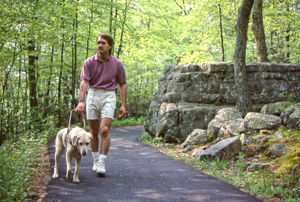 Man & Guide Dog on Accessible Trail