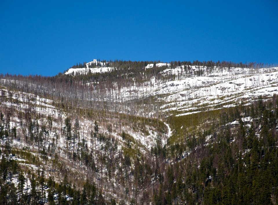 Snow-covered Webb Mountain Lookout from Lake Koocanusa