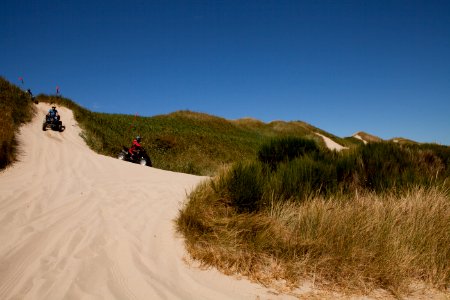 Dune Buggy Riders Descending Sand Dune at Oregon Dunes, Siuslaw National Forest photo