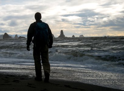 Hiker on the Pacific Northwest Trail at Third Beach, Olympic National Park photo