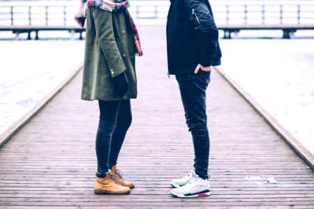 Two people standing on the pier