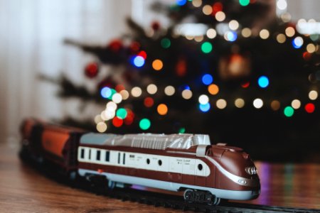 A toy train going around the Christmas tree photo