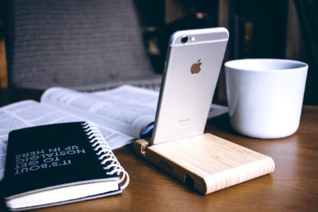 iPhone in a wooden phone holder photo