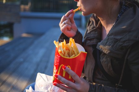 Girl eating french fries photo