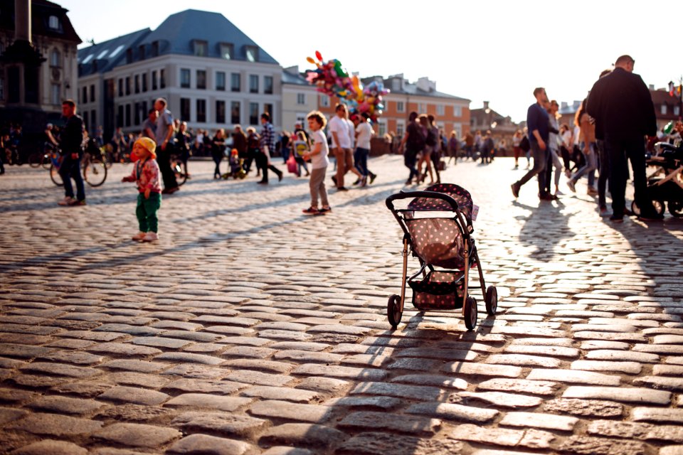 An empty stroller in a crowded Old Town square photo