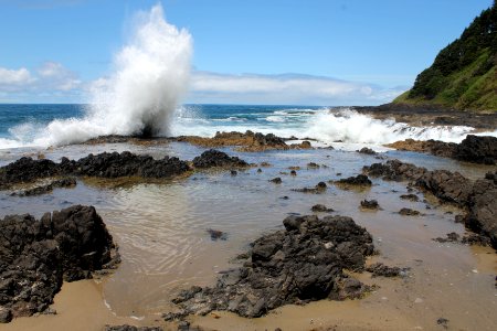 Tidepool and crashing waves at Cape Perpetua on the Siuslaw National Forest photo