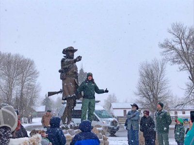 Nikki Swanson speaking in front of the Jim Bridger statue
