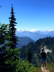 Hiker-LookingOutAtMtnRange-OkaWenNFbyMasonSchuurUSFS-Aug7-2018