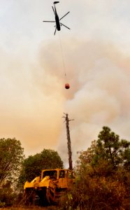 A bulldozer and helicopter are powerful tools for fire suppression, water drop on South Obenchain Fire, 9-10-2020