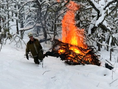 201902 CRGNSA Roland Rose, Forest Service Fire Fuels Assistant Fire Management Officer, pile burning in the snow.