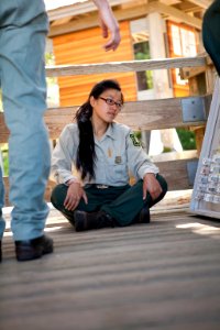 Young Asian Field Ranger Sitting at Oregon Dunes Day Use Area, Siuslaw National Forest
