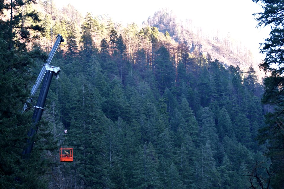 Workers removing the suspension bridge at Eagle Creek.
