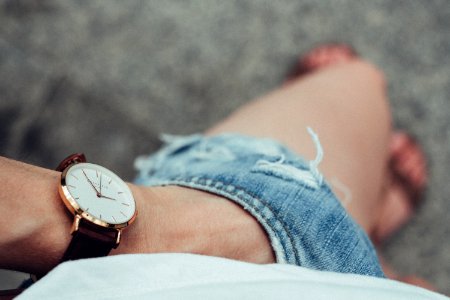 Female hand in ripped shorts photo