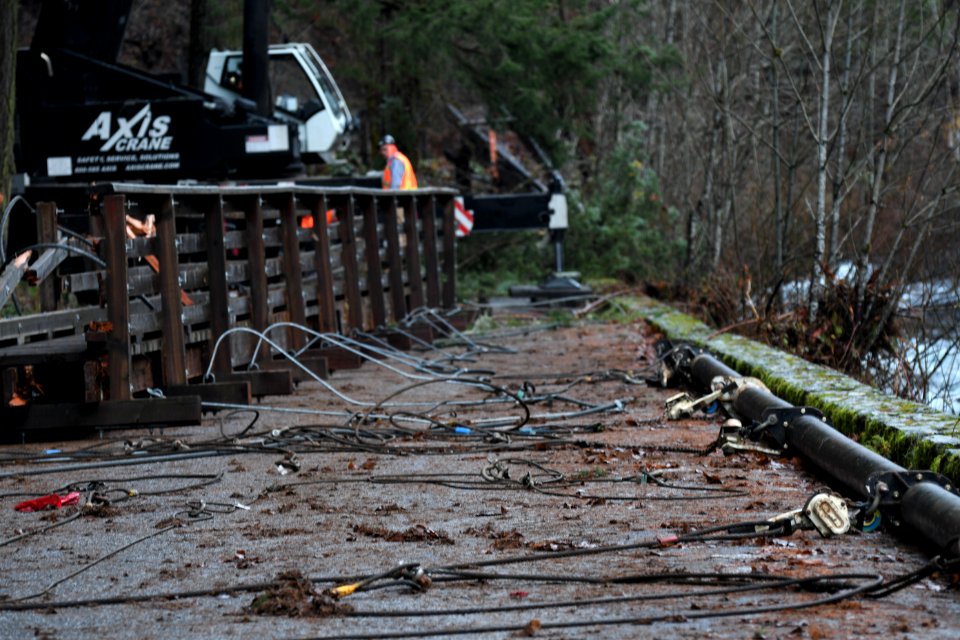 Cables lay next to the suspension bridge that was remved at Eagle Creek for public safety and to minimize further damage to nearby resources such as roads and the fishery,
