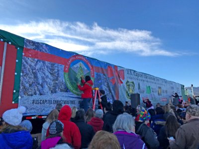 People signing banner
