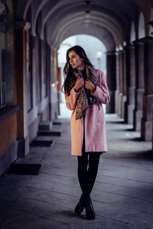 A woman posing under arcades photo