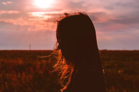Girl's head silhouette at sunset photo