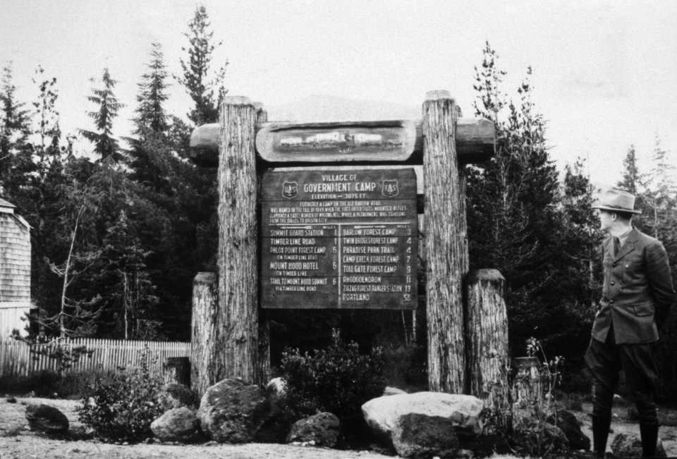 006 Government Camp, ranger poses at newly carved Forest sign