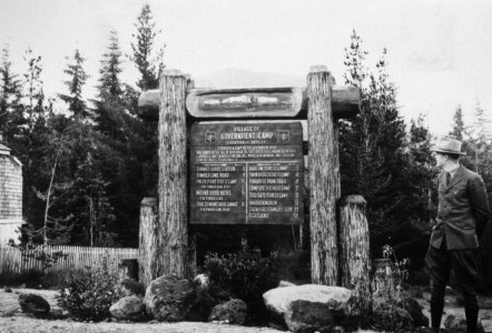 006 Government Camp, ranger poses at newly carved Forest sign