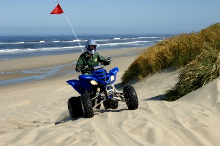 Woman Field Ranger riding Dune Buggy at Oregon Dunes, Siuslaw National Forest