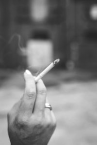 Hand holding a cigarette photo