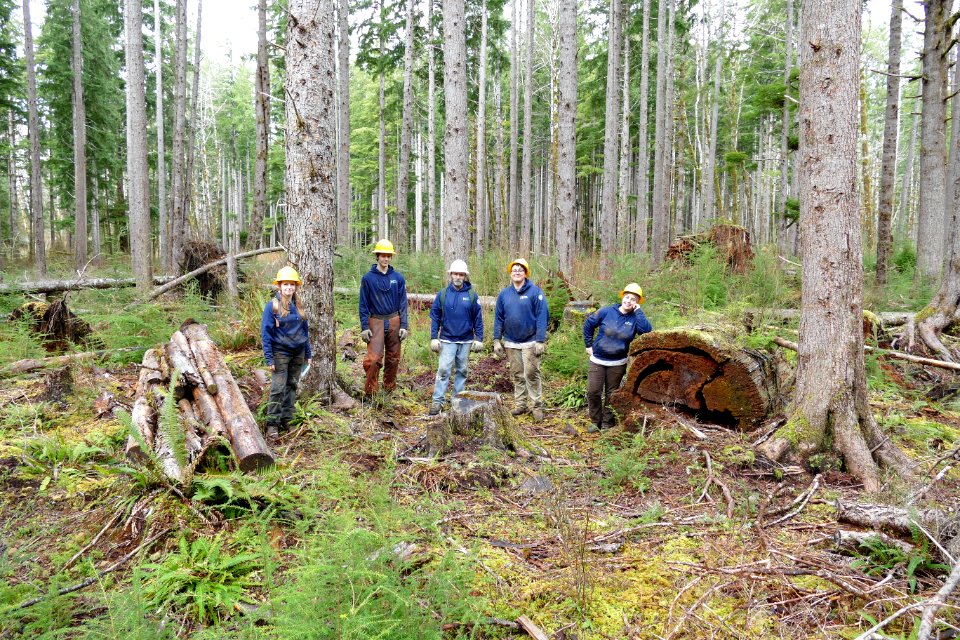 20200225 Olympic WCC crew near log they created for the forest and old log USFS photo.